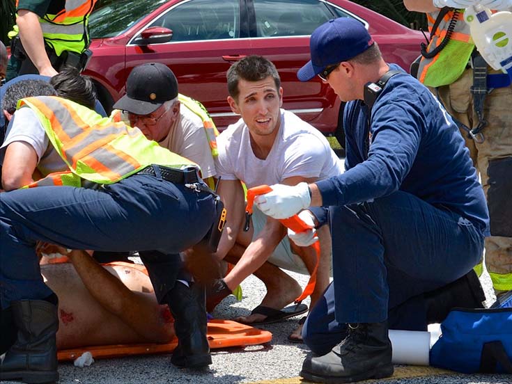 Derrick Layer, RRT — second from right — was off duty and on his way to the beach when he rushed to help save a man involved in a motorcycle crash. This photo was taken after paramedics had arrived.